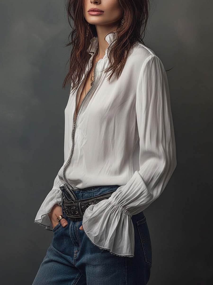 Blusa blanca con cremallera frontal y puños con volantes